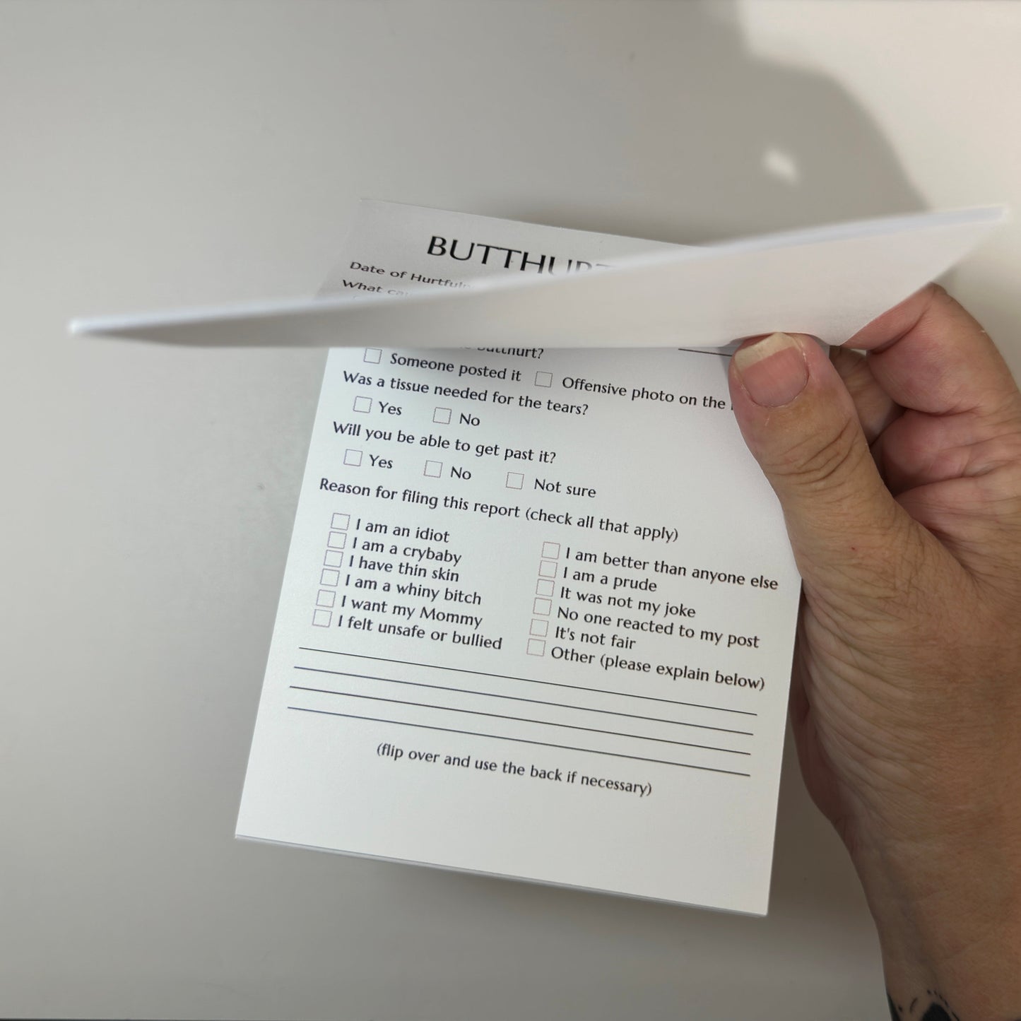 Funny and playful Butthurt Report notepad with sarcastic checkboxes, perfect for office humor, adult gag gifts, or playful workplace fun