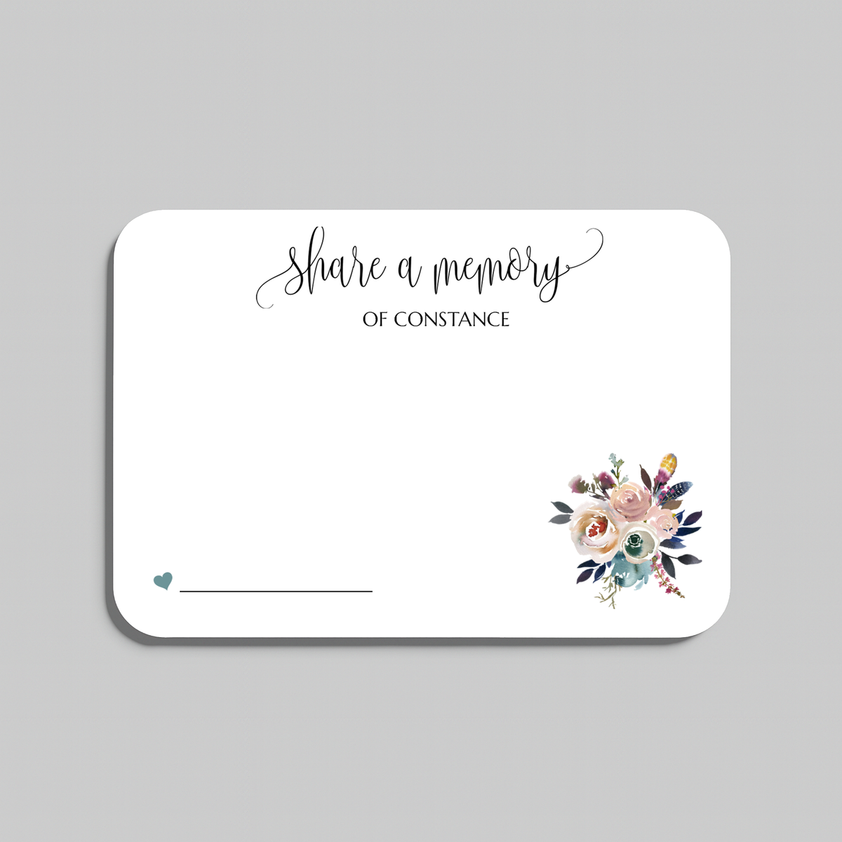 A rectangular white wedding reception seating card with rounded corners, featuring the script text share a memory at the top, a small teal heart and line at the bottom left, and a watercolor floral bouquet illustration at the bottom right. The card is shown on a neutral gray background.