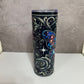 Tumbler with floral and butterfly design on a gray background