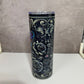 Tumbler with black floral design on a gray background