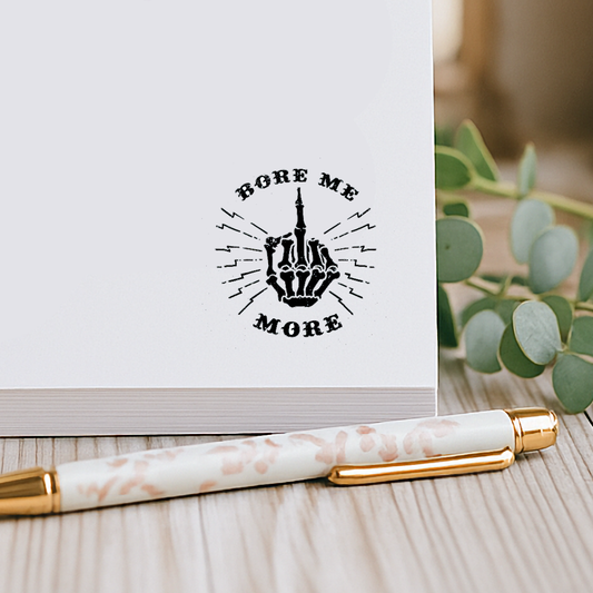 Fun and playful notepad with cheeky middle finger design and “Bore Me More” phrase, perfect for sassy stationery lovers and gag gift ideas