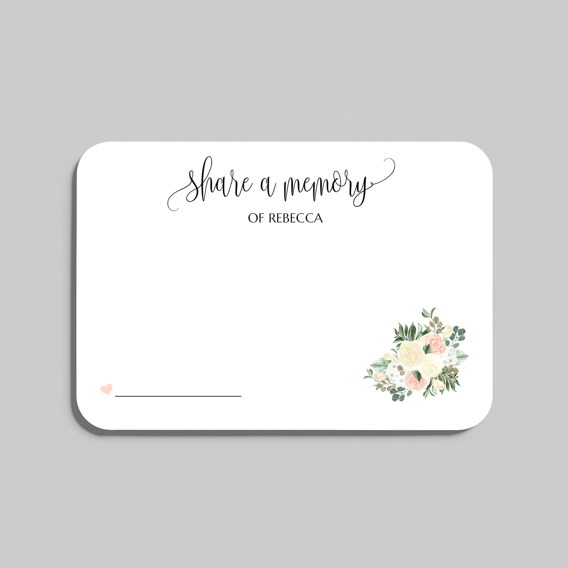 A rectangular white memorial card with rounded corners, printed with the words 'share a memory' in black script and serif text, plus a small floral bouquet illustration in soft pink, cream, and green near the lower right. The card is shown on a light gray background.