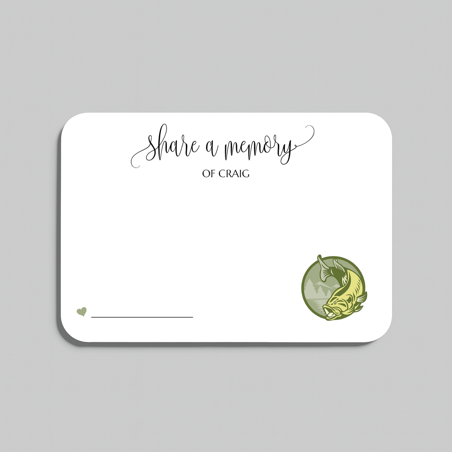 A white rectangular memorial card with rounded corners, featuring the printed text 'share a memory' in black script and serif type, a small heart and line in the lower left, and a green circular illustration of a bass fish in the lower right. The card is centered on a light gray background.