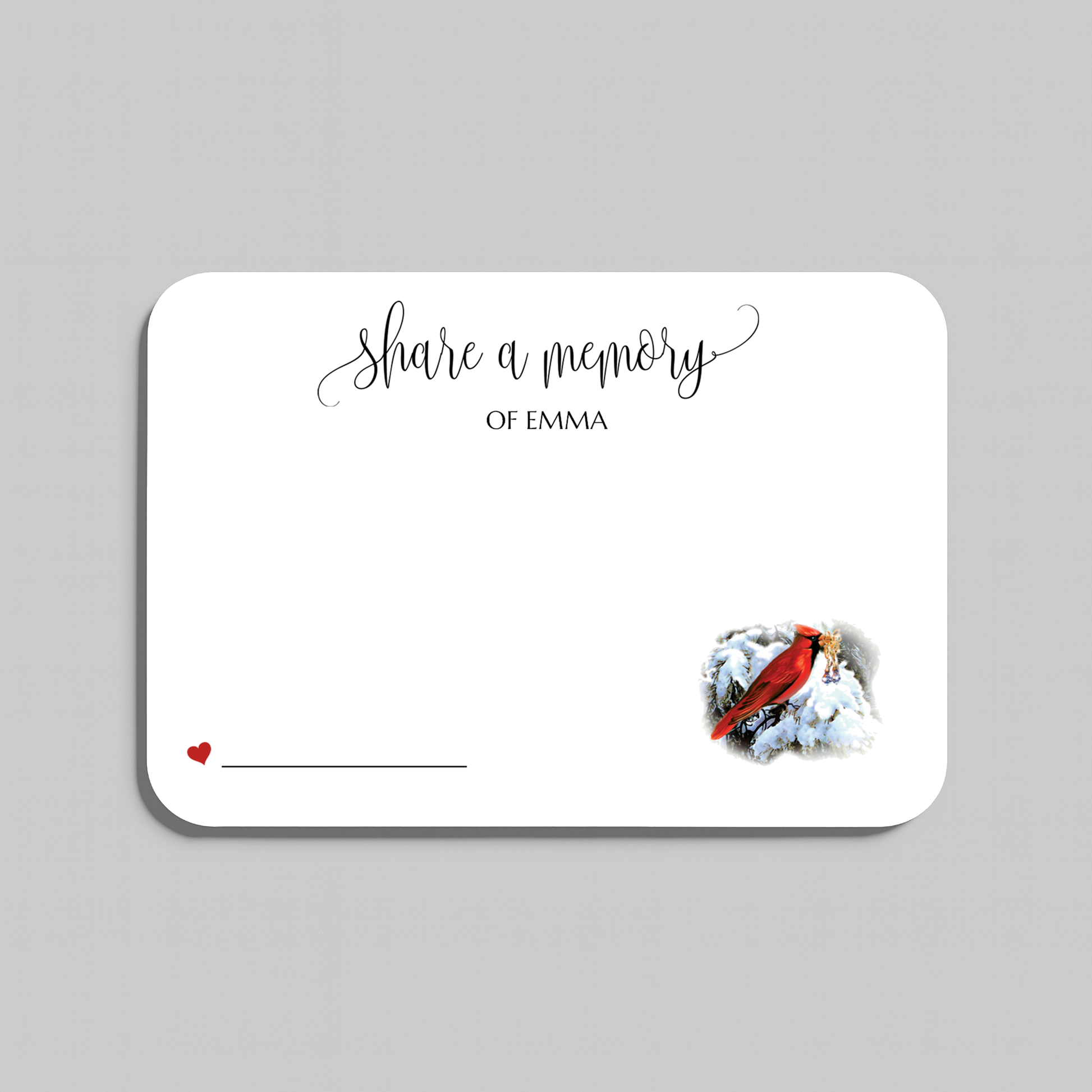 A memorial card with rounded corners on a light gray background. The card is white with black script text reading 'share a memory' a small red heart and line in the lower left, and a small red cardinal perched on white snow in the lower right.
