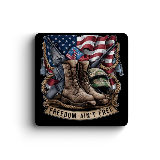 Patriotic magnet featuring combat boots, American flag, military gear, and Freedom Ain’t Free banner