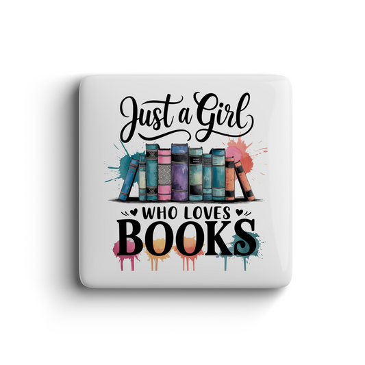Magnet featuring colorful books and the quote “Just a Girl Who Loves Books” with vibrant paint splashes